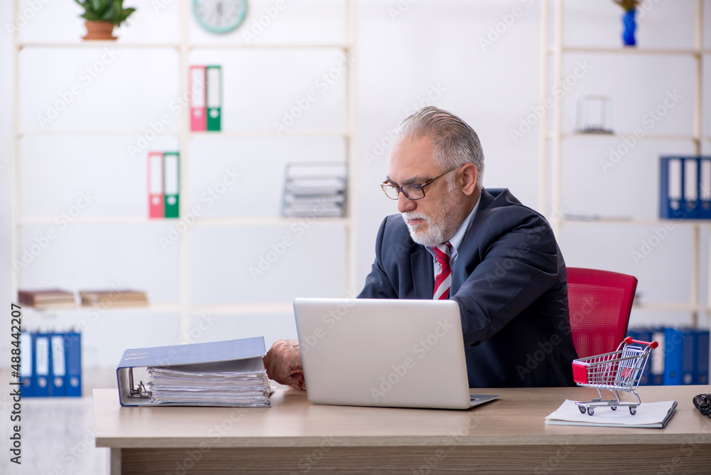 Old male employee in e-commerce concept Old male employee in e-commerce concept