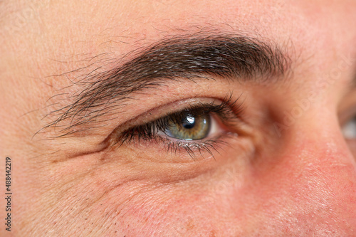Schilderij op canvas Macro of a man's eye with wrinkles and crow's feet