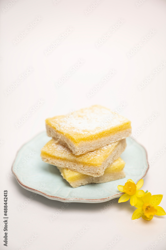 Lemon squares stacked on a plate Lemon squares stacked on a plate