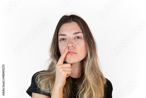Young girl doesn't love her lips. She holding and stretching her lips. She wants to make plastic surgery. Labiaplasty. Medical operations. photo