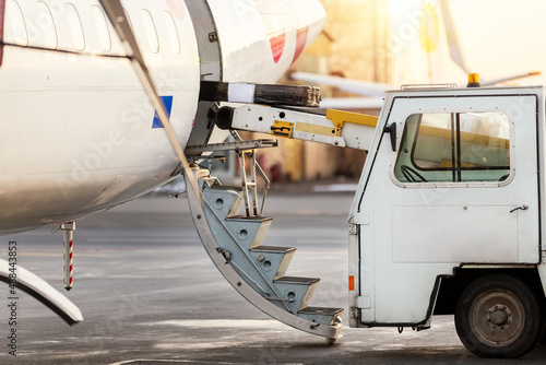 Close-up detail view of belt loading machine car load commercial parcel shipment in small cargo plane compartment. Air mail shipping and logistics service . Commercial charter flight service