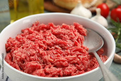 Fresh minced meat in bowl on table, closeup