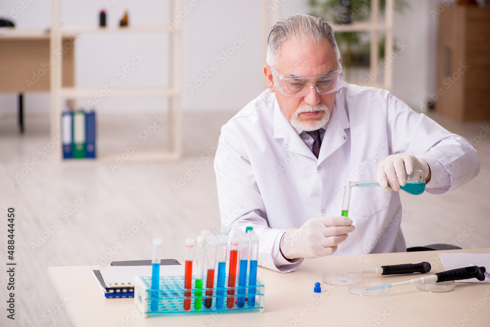 Old male chemist working in the lab Old male chemist working in the lab