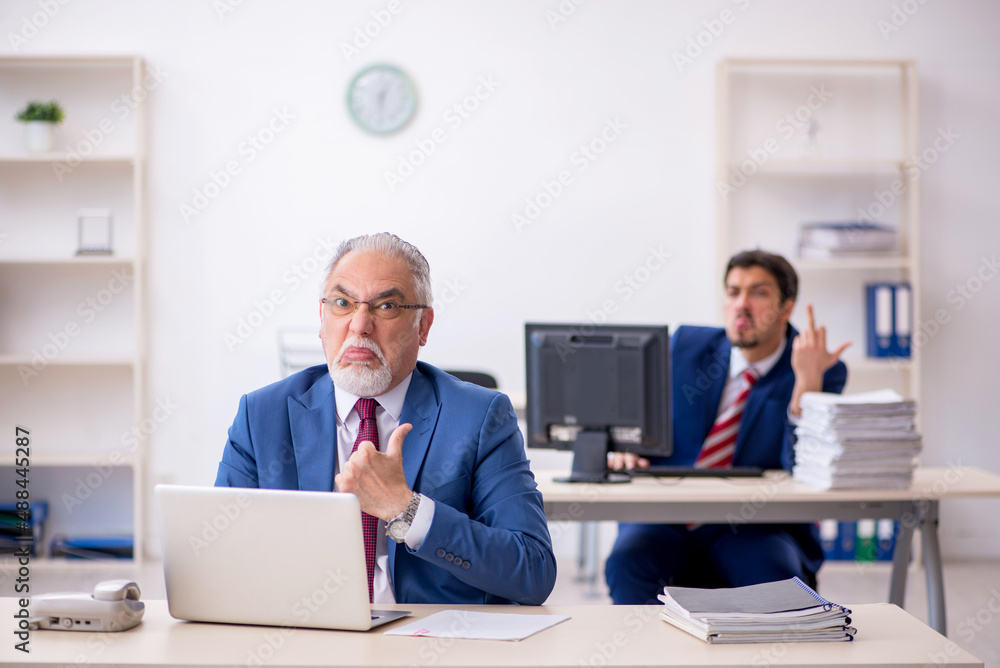 Two male colleagues working in the office Two male colleagues working in the office