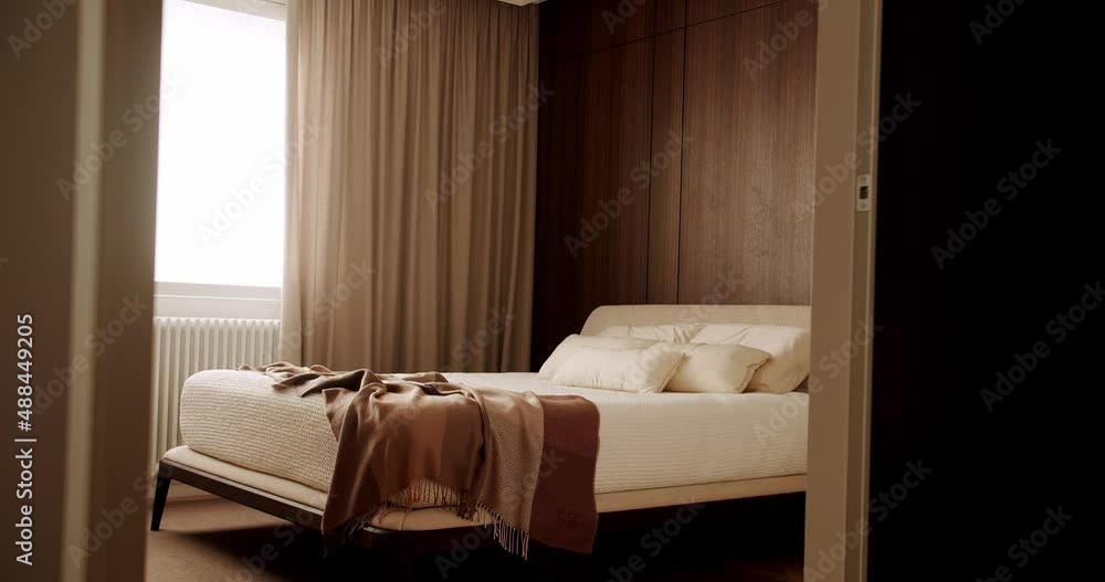 Interior of modern luxury bedroom with furniture. Elegance interior design. Minimalist Bedroom. Modern Hotel Bedroom Interior and bed with many pillows. Interior with wood on the wall. Real Estate. Interior of modern luxury bedroom with furniture. Elegance interior design. Minimalist Bedroom. Modern Hotel Bedroom Interior and bed with many pillows. Interior with wood on the wall. Real Estate.