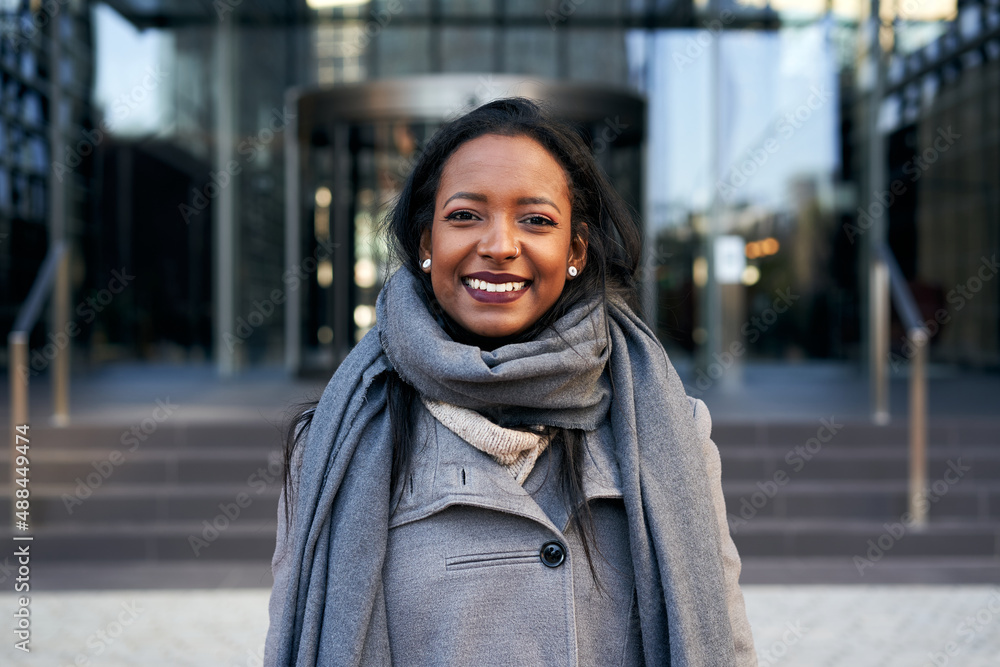 Young African American businesswoman looking camera smiling. Cheerful lady smiling for the successes of work. Young African American businesswoman looking camera smiling. Cheerful lady smiling for the successes of work.