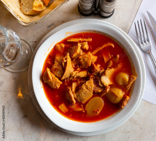 Traditional French dish, provencale tripes, served in bowl with serving pieces. photo