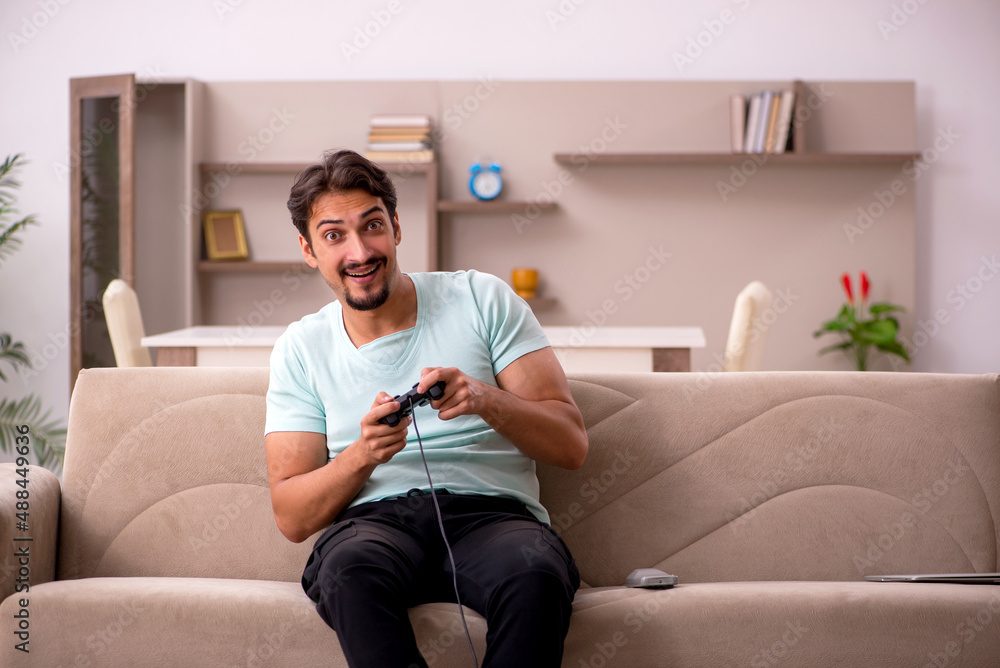 Young man playing joystick games at home Young man playing joystick games at home