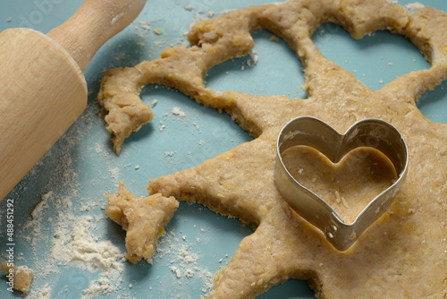 Bild auf Leinwand Heart-shaped cookie cutter on dough