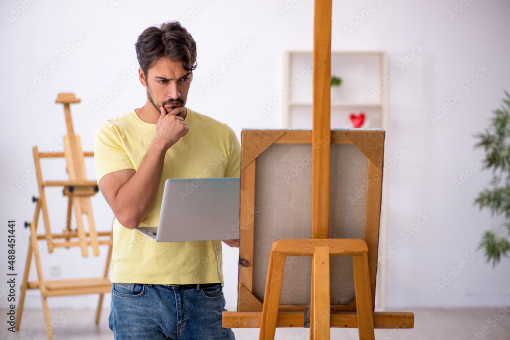 Young man enjoying painting at home Young man enjoying painting at home