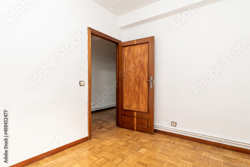 Wallpaper Mural Empty living room with wooden door, oak parquet flooring and white painted walls Torontodigital.ca