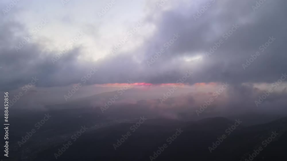Aerial reveal shot from above at high altitude of dense puffy cumulus clouds flying in evening. Amazing sunset from airplane window point of view Aerial reveal shot from above at high altitude of dense puffy cumulus clouds flying in evening. Amazing sunset from airplane window point of view