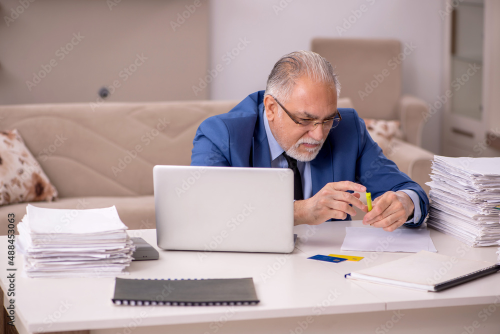 Old male boss working from home during pandemic Old male boss working from home during pandemic
