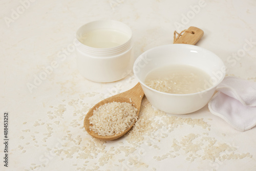 white bowls with rice and rice water  fermented skin and hair care products  organic cosmetics  light background