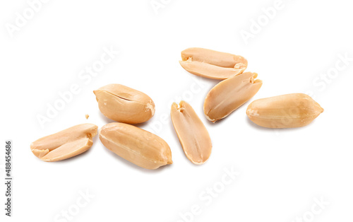 peeled roasted whole and halves of peanuts close-up isolated on white background 