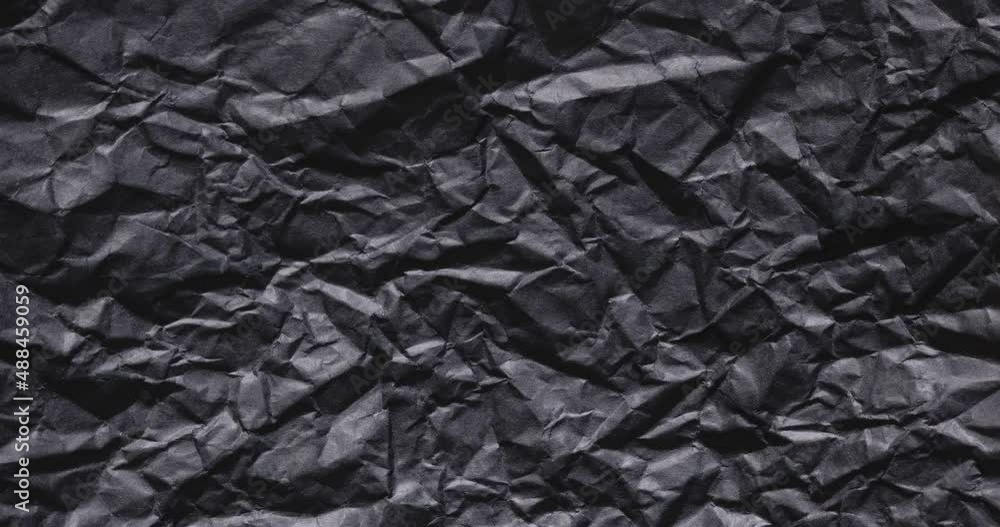 Stop-motion shot of quickly-changing black crumpled paper. Stop-motion shot of quickly-changing black crumpled paper.