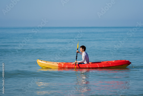 man paddling a kayak boat in sea © geargodz