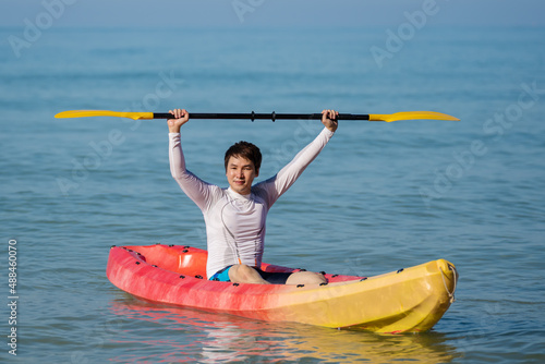 man paddling a kayak boat in sea
