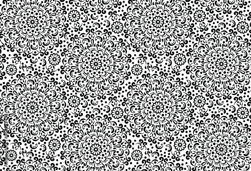 Seamless, monochrome black and white mandala floral surface pattern print design for textiles and backgrounds. Multi directional black and white hand drawn vector illustration.