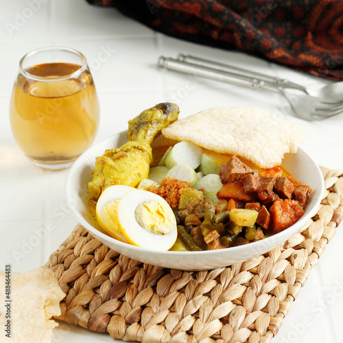 Lontong Sayur Medan, Traditional Indonesian Food, Coconut Broth with Vegetable, Rice Cake, Egg, Rendang Chili, Crackers Krupuk.