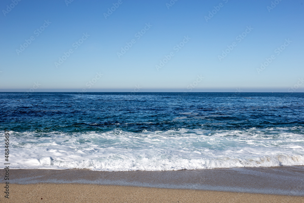 A view on the Pacific ocean seashore with blue sky