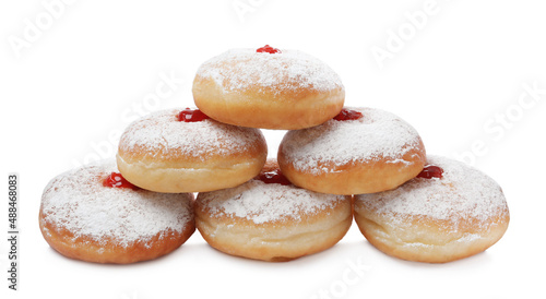 Delicious donuts with jelly and powdered sugar on white background