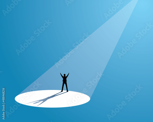 Happy businessman celebrating victory under bright spotlight, recruitment hiring in business