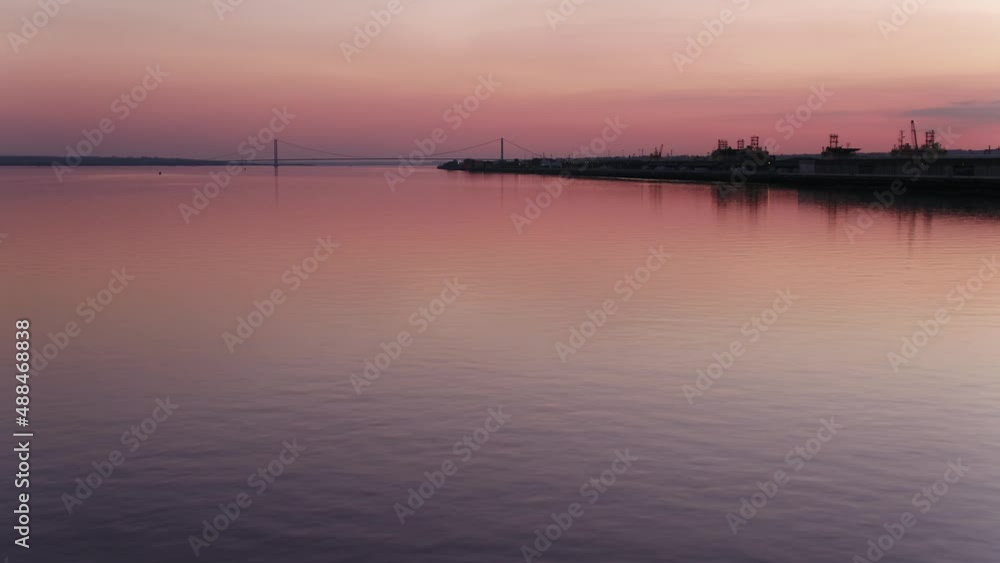 Sunset pink skies with a low flight over glass water of the Humber with the Humber Bridge in the distance. Sunset pink skies with a low flight over glass water of the Humber with the Humber Bridge in the distance.