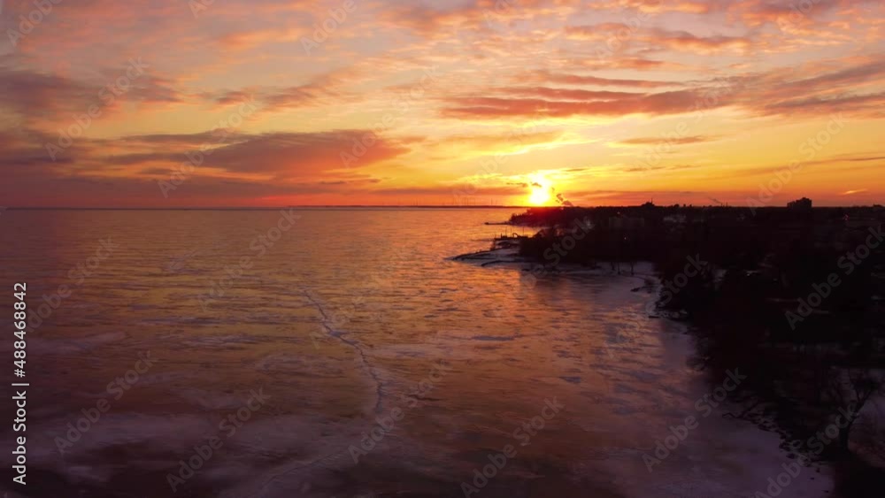 Aerial going over a frozen Lake during a sunset Aerial going over a frozen Lake during a sunset