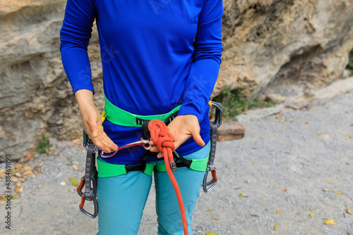 Rock climber making a eight knot