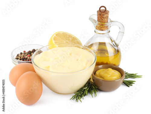 Delicious homemade mayonnaise, spices and ingredients on white background
