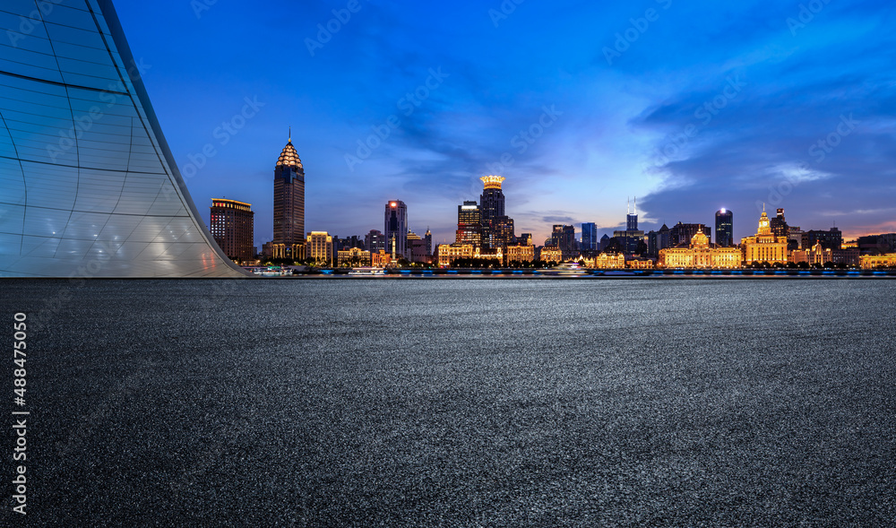 Fototapeta premium Asphalt road and city skyline with modern commercial buildings in Shanghai at night, China.