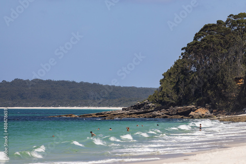 Unidentifiable people playing in the water at Hyams beach  near Jervis Bay in NSW, Australia photo