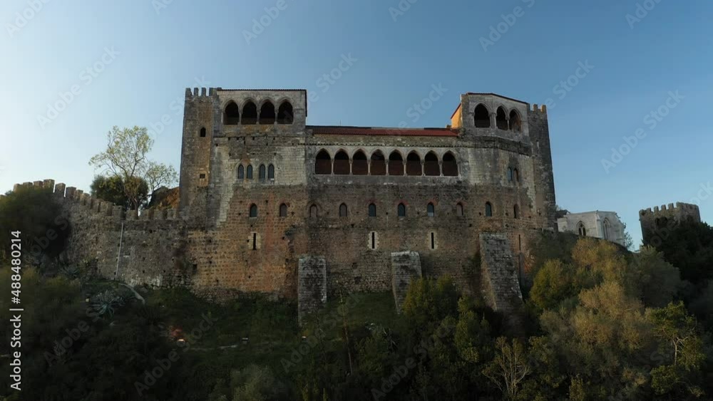 Solid Exterior Wall Of The Castle Of Leiria On A Clifftop In Leiria, Portugal. low angle, drone ascend Solid Exterior Wall Of The Castle Of Leiria On A Clifftop In Leiria, Portugal. low angle, drone ascend