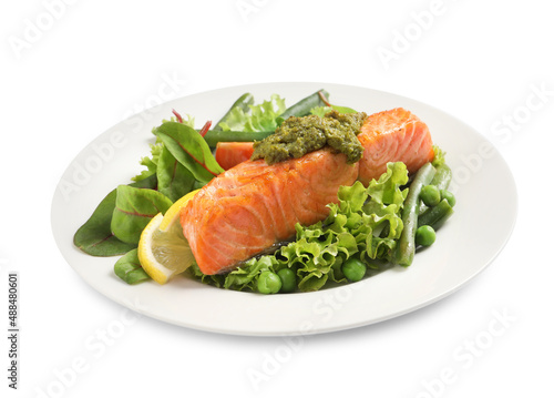 Tasty cooked salmon with pesto sauce and fresh salad on white background