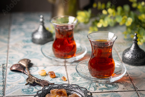 Turkish tea in traditional glass closeup on tile background