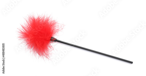 Red feather tickler on white background, top view. Sex toy