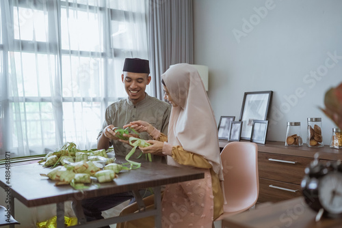 couple making ketupat for eid mubarak together