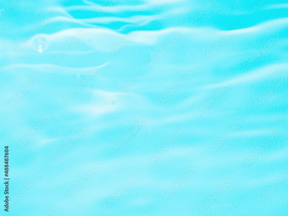 Ripple water texture on blue pool background. Shadow of water on sunlight. Mockup for product, spa or travel background. Marble blue water surface as wallpaper background Ripple water texture on blue pool background. Shadow of water on sunlight. Mockup for product, spa or travel background. Marble blue water surface as wallpaper background