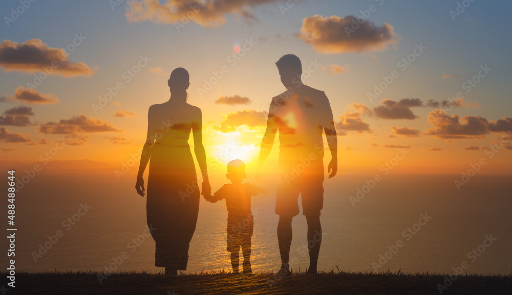 Family of there walking together into the sunset holding hands. Family future beginnings concept. 