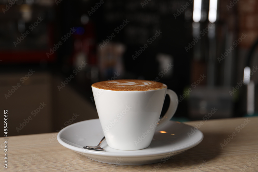 Cup of aromatic coffee on wooden table in cafe Cup of aromatic coffee on wooden table in cafe