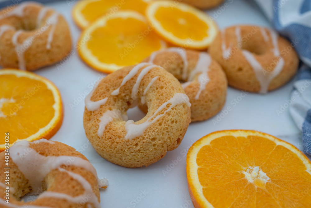 sweet home made orange donuts on a table