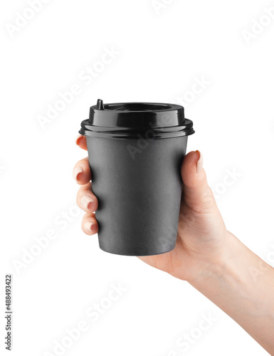 A paper cup of coffee in the hand isolated. Mock-up.
