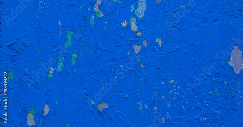 Background blue spots on cracked stucco.