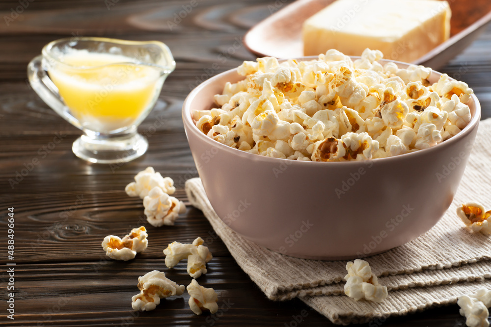 Popcorn bowl and melted butter on kitchen table