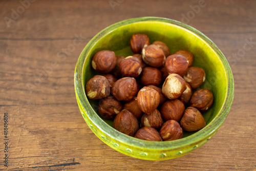 hazelnut kernels, isolated on wooden surface.. close-up