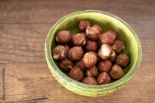 hazelnut kernels, isolated on wooden surface.. close-up