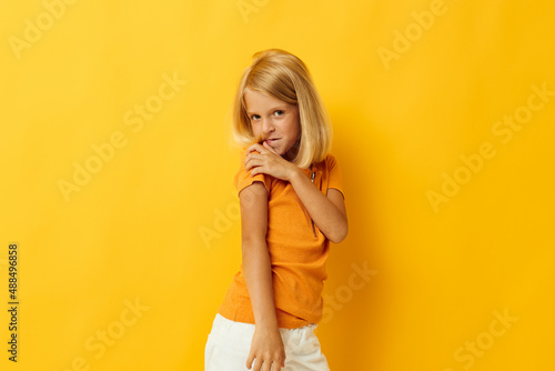 portrait of a little girl smile hand gestures posing casual wear fun isolated background unaltered