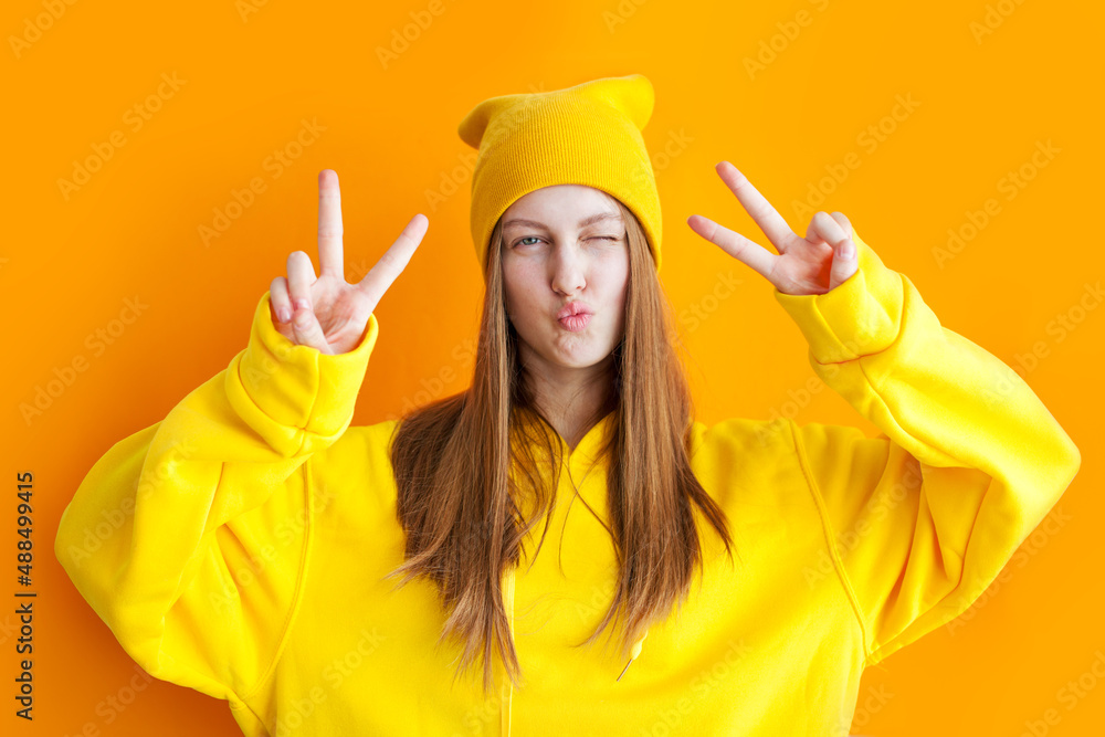 Young teen girl wearing yellow hoodie and hat, Hipster Young teen girl wearing yellow hoodie and hat, Hipster