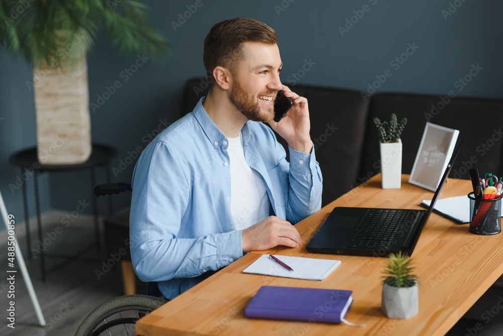 Man in wheelchair at home or in office. Man in wheelchair at home or in office.